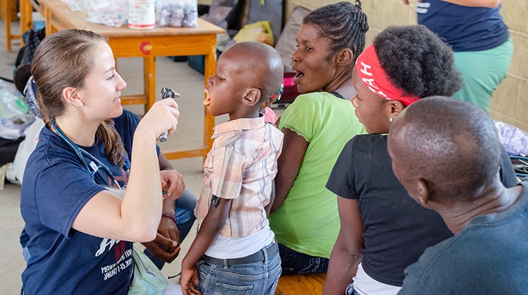 Doctor examining a small boy. Part of a medical mission in Haiti.