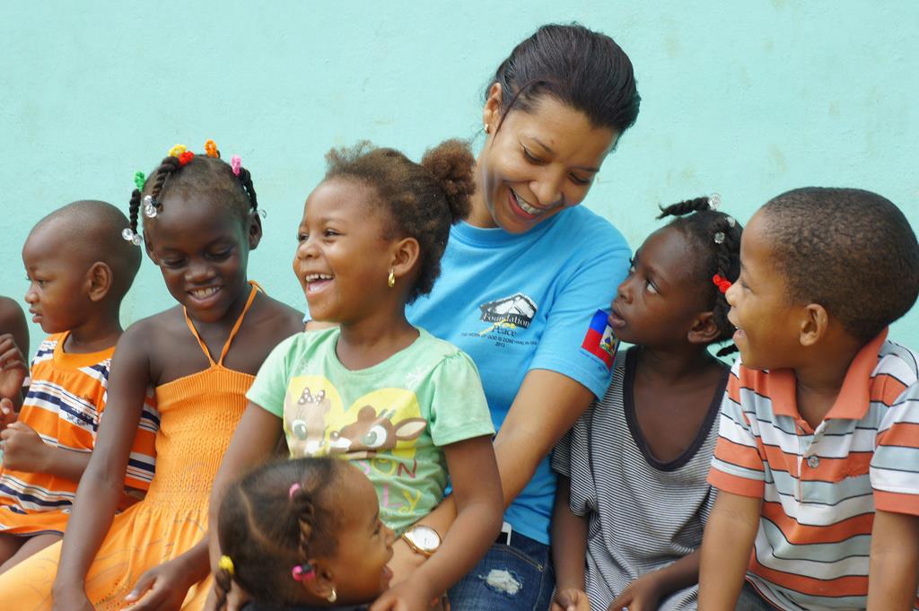 Cici Lugo sitting with children